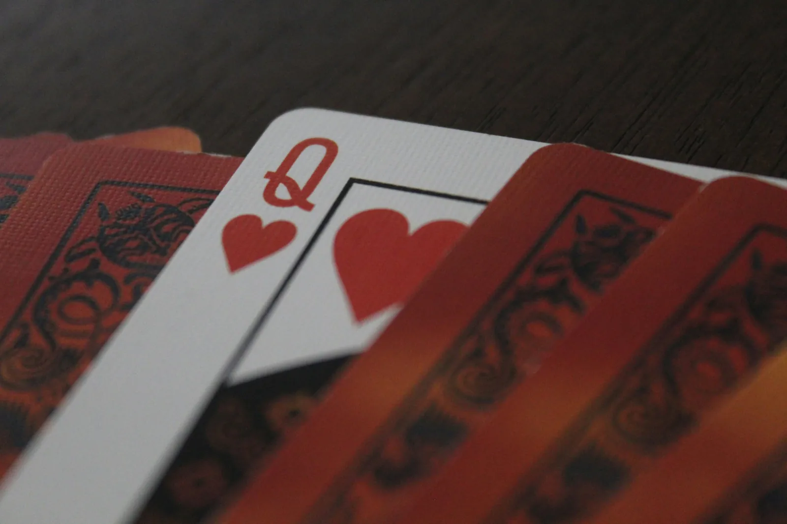 The queen of hearts among a fan of cards