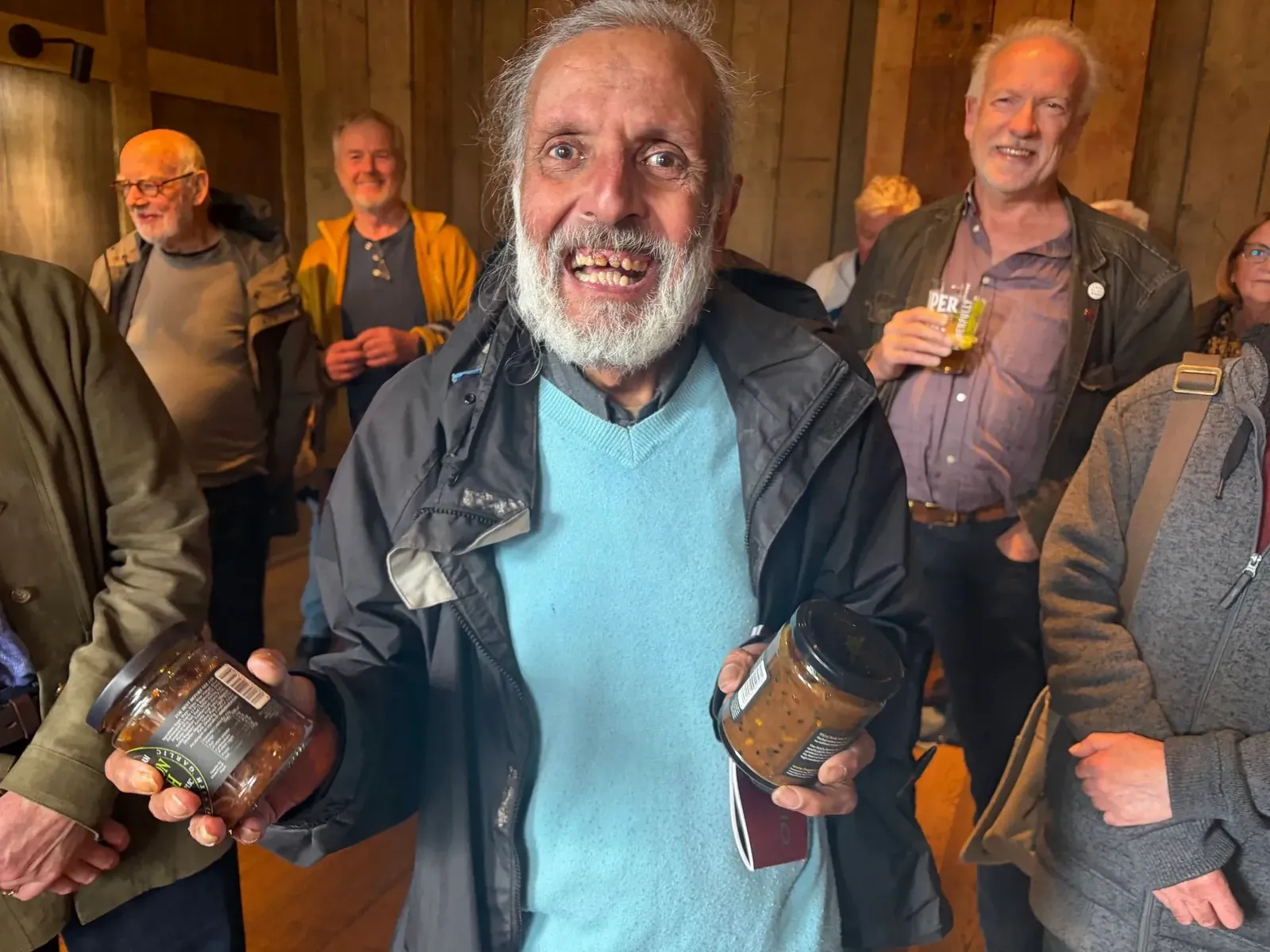 A prize winner holding up two jars of chutney